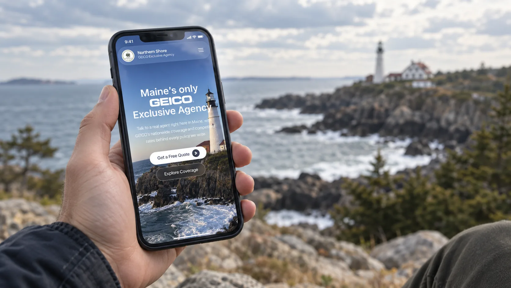 Northern Shore Insurance lighthouse homepage shown on a phone by the coast